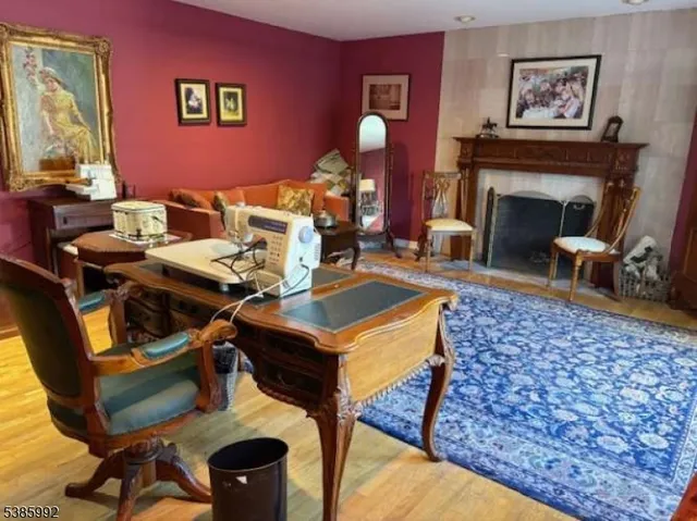 a living room with furniture a rug and a fireplace