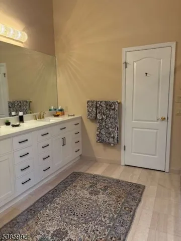 a bathroom with a bathtub sink and mirror