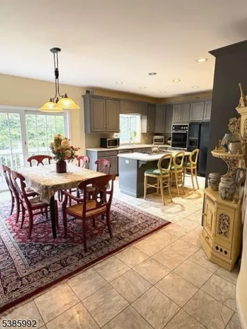 a dining room with a table chairs and a open kitchen view