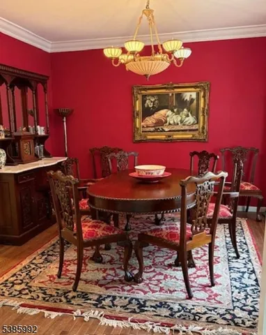 a view of a dining room with furniture and chandelier