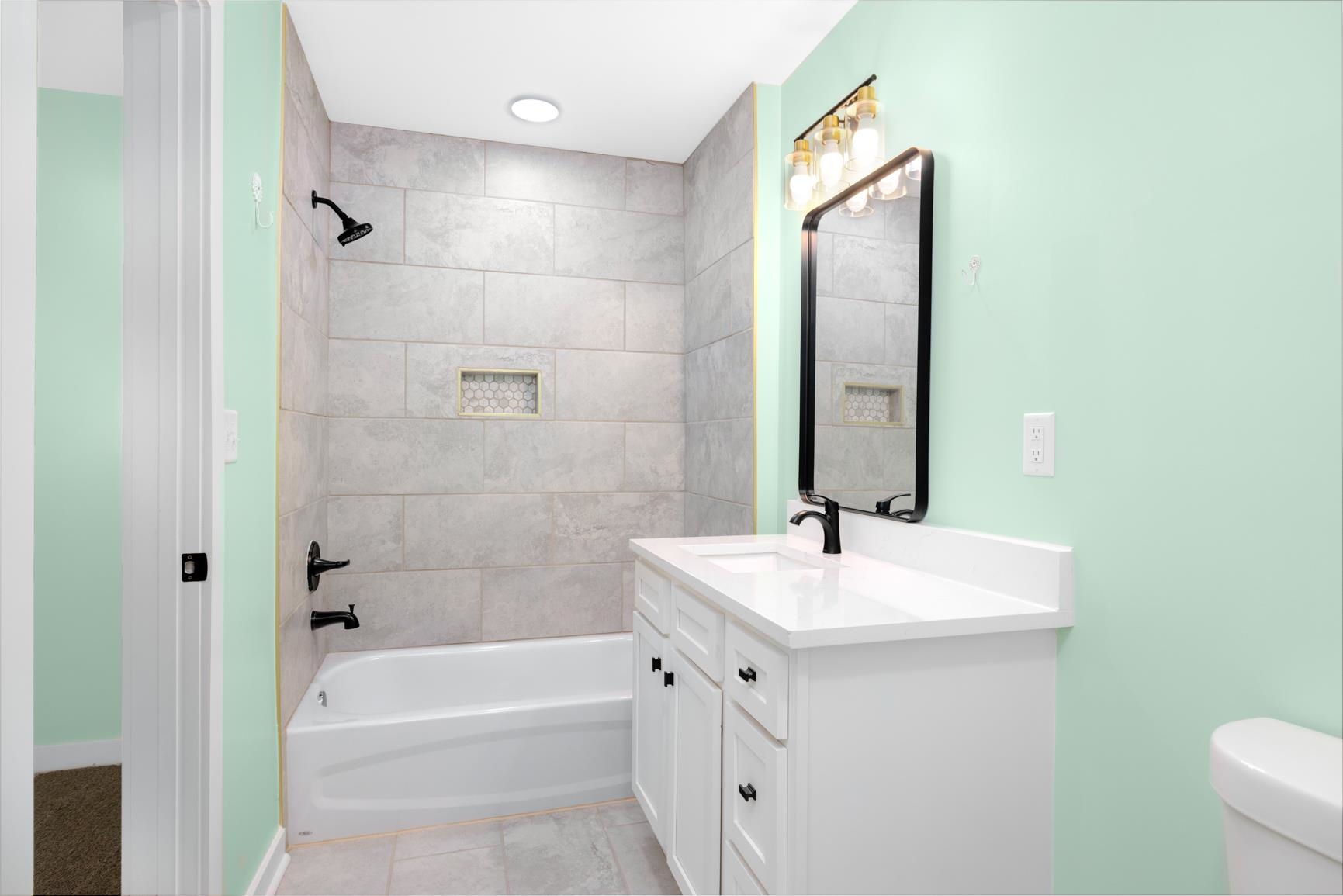 5702 Spring Lake Road Memphis, TN 38135 - Photo 36 of 40 Bathroom featuring a white vanity with countertop, rectangular sink, and matte black faucet
