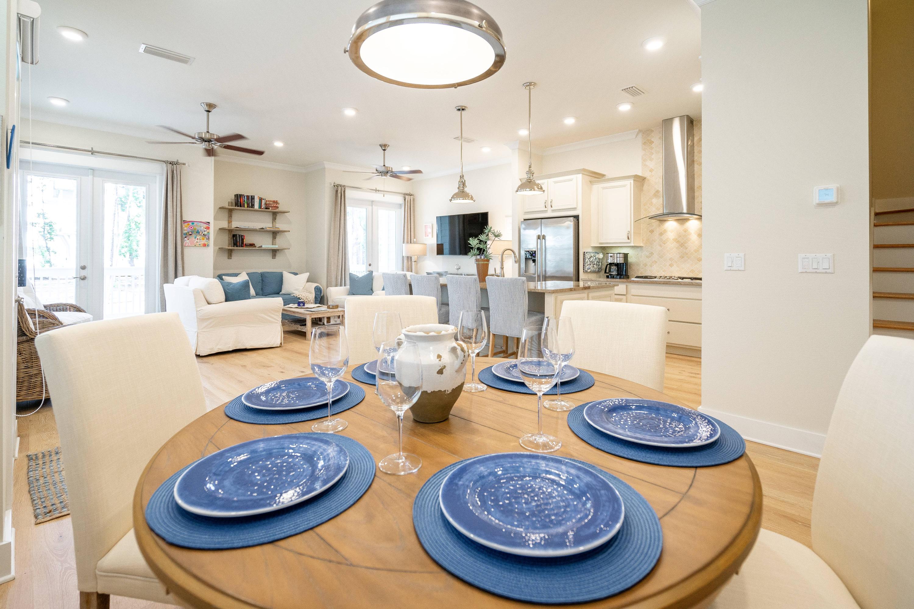 89 East Pine Lands Loop, Unit A Inlet Beach, FL 32461 - Photo 3 of 41 a dining room with furniture a rug and kitchen view