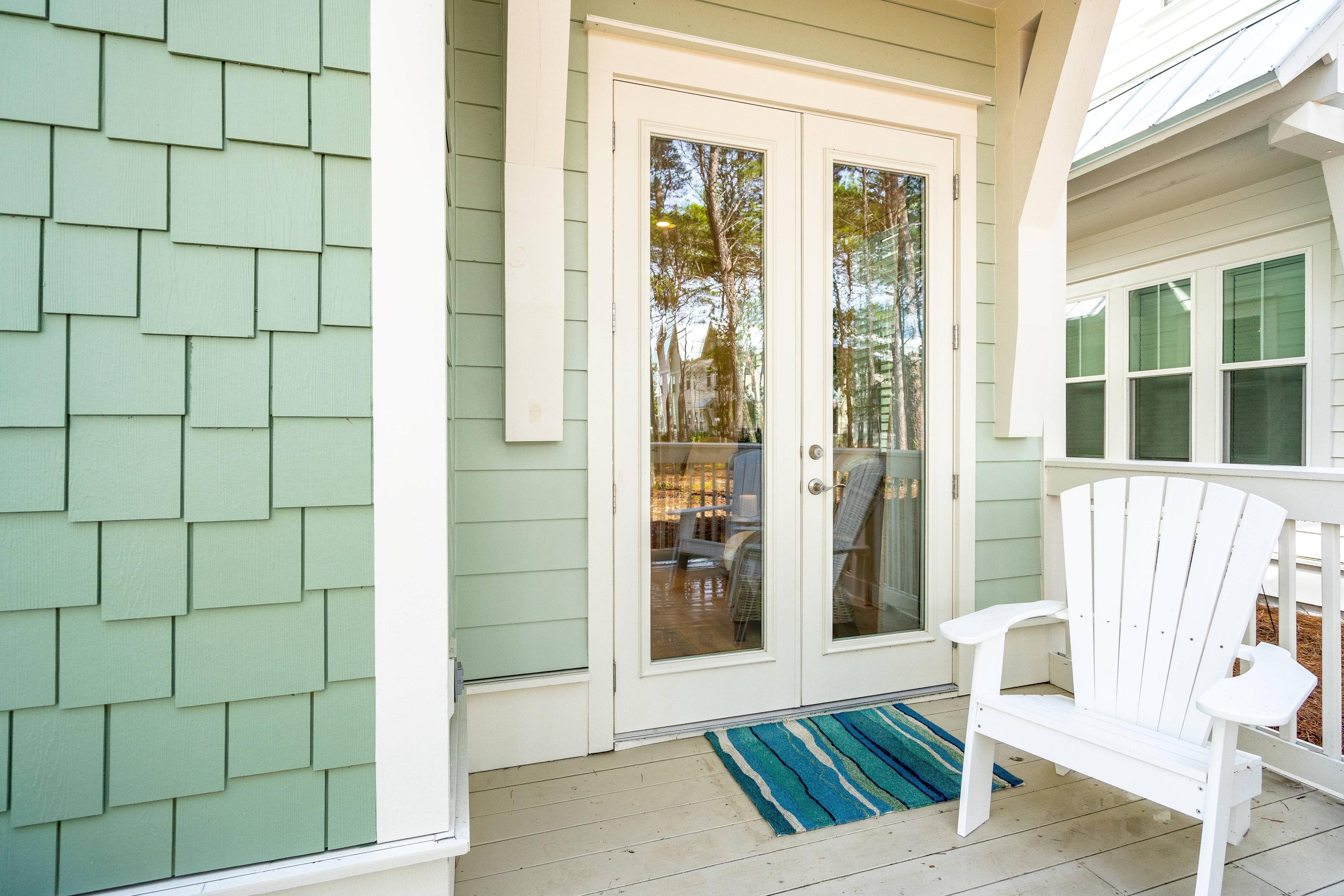 89 East Pine Lands Loop, Unit A Inlet Beach, FL 32461 - Photo 25 of 41 a view of a porch with a chairs and table