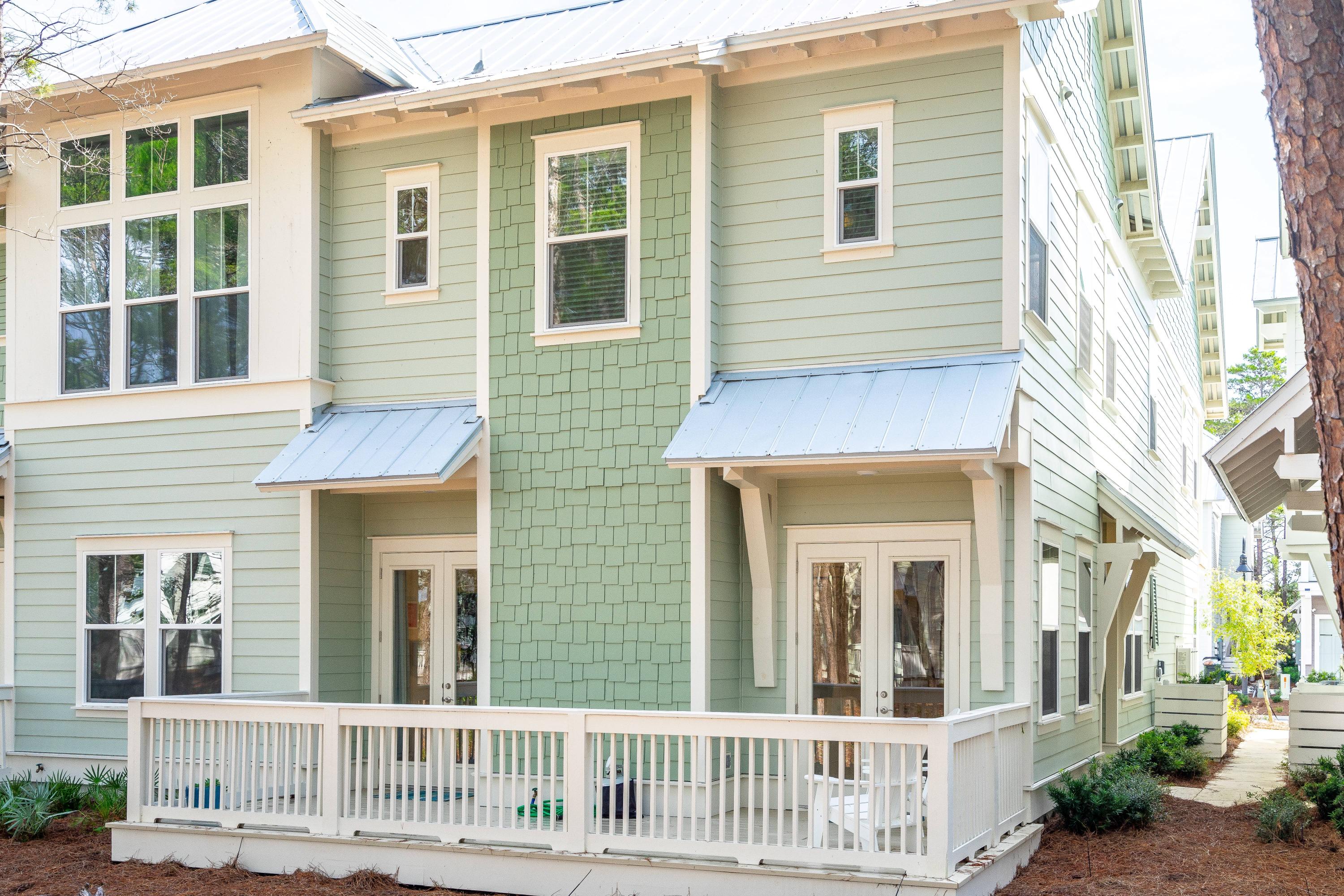 89 East Pine Lands Loop, Unit A Inlet Beach, FL 32461 - Photo 26 of 41 a view of a brick house with large windows