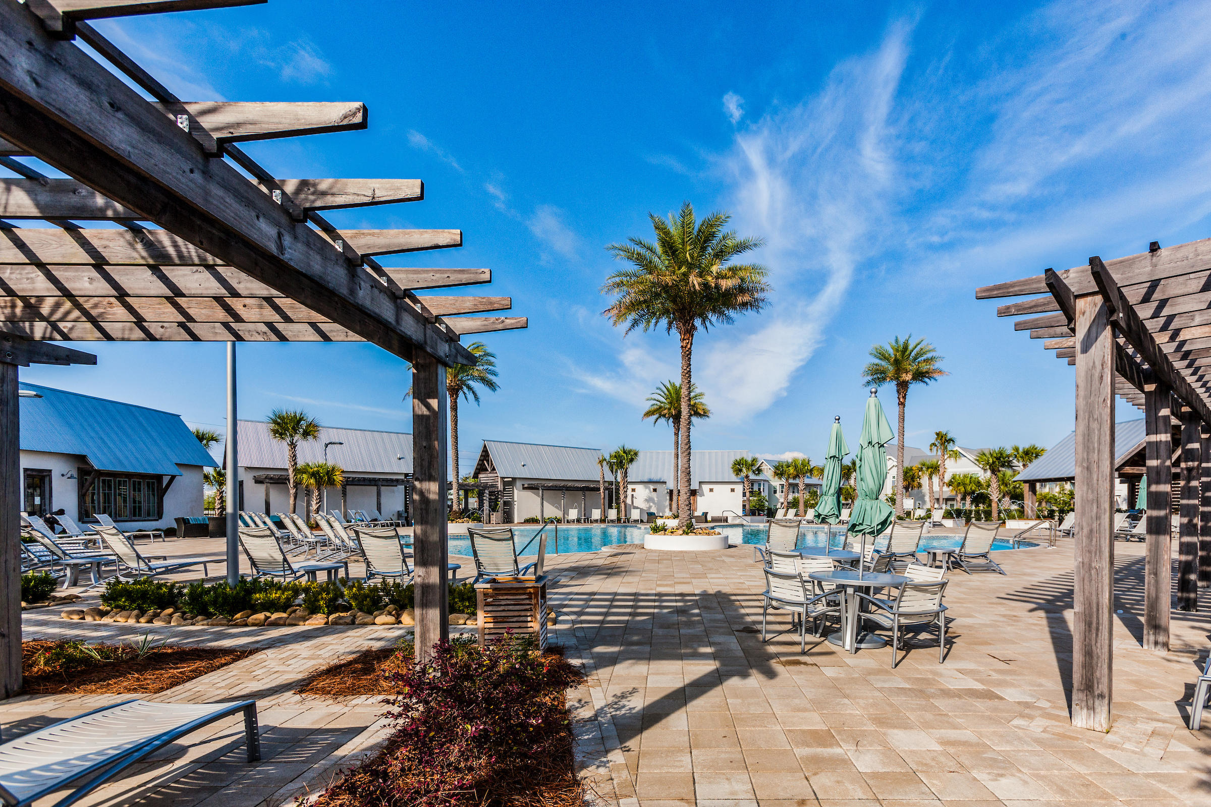89 East Pine Lands Loop, Unit A Inlet Beach, FL 32461 - Photo 29 of 41 a view of a swimming pool with a table and chairs