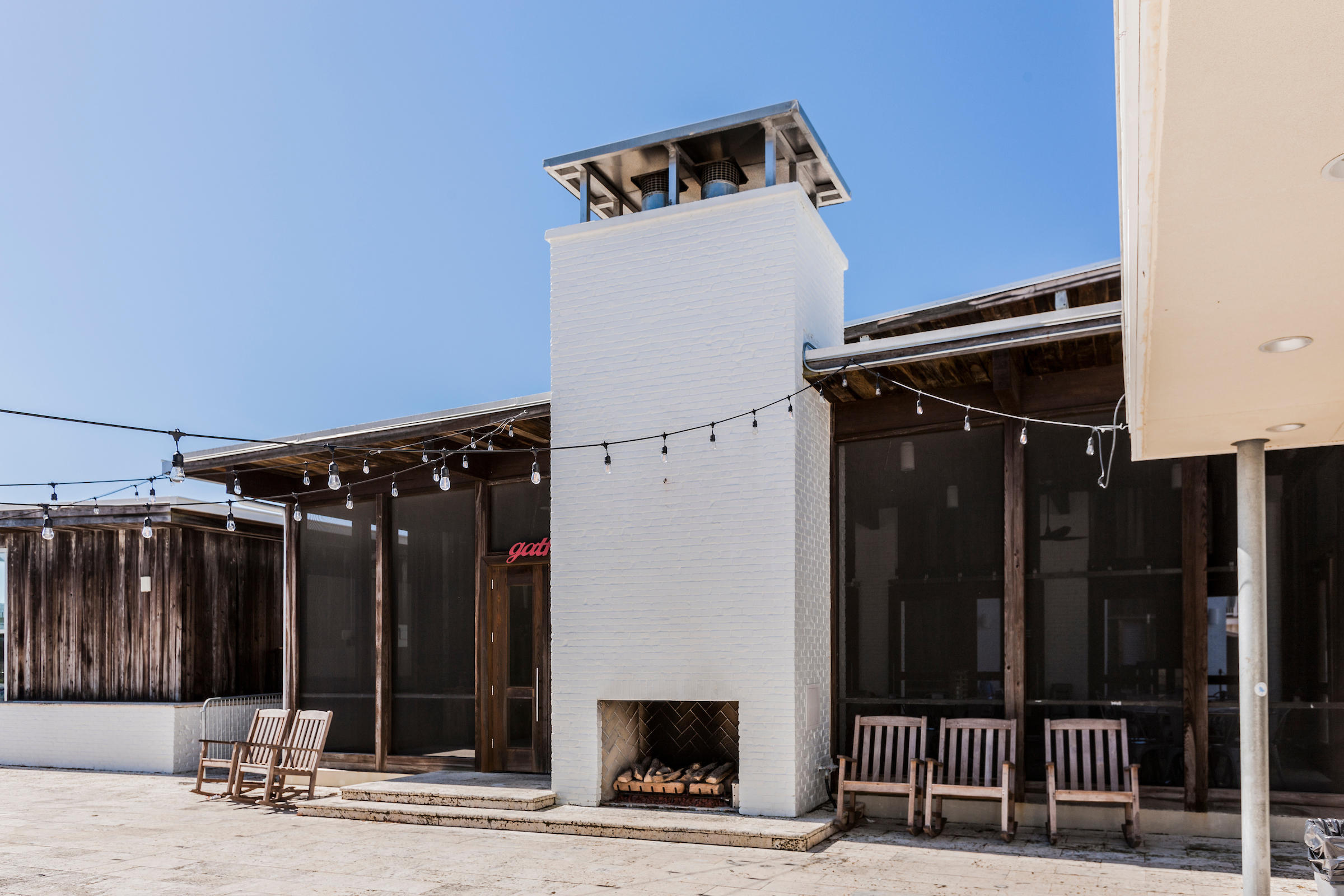89 East Pine Lands Loop, Unit A Inlet Beach, FL 32461 - Photo 36 of 41 a view of a house with a door and wooden fence