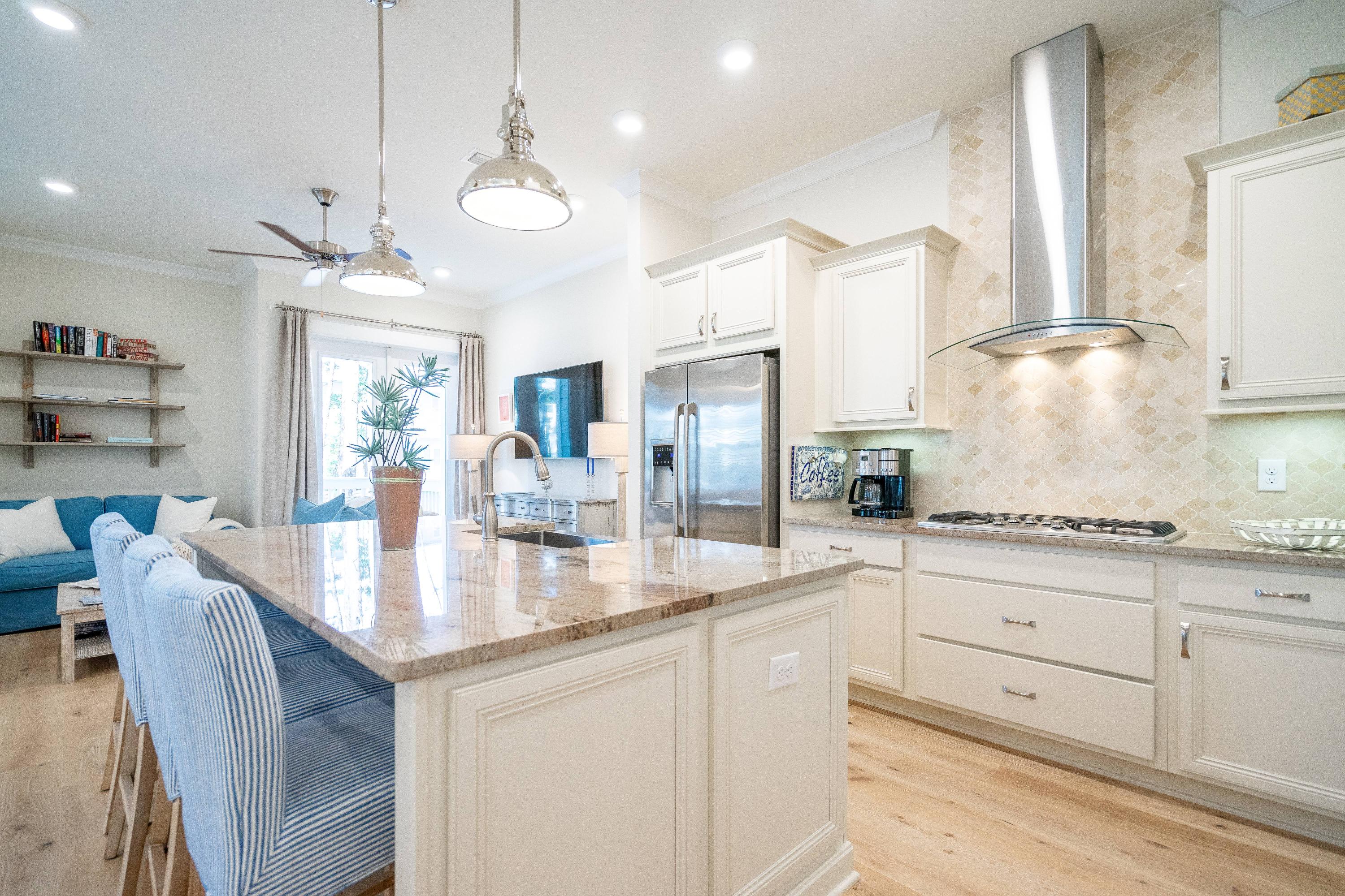 89 East Pine Lands Loop, Unit A Inlet Beach, FL 32461 - Photo 5 of 41 a very nice looking kitchen with granite countertop a stove two sinks and a chandelier