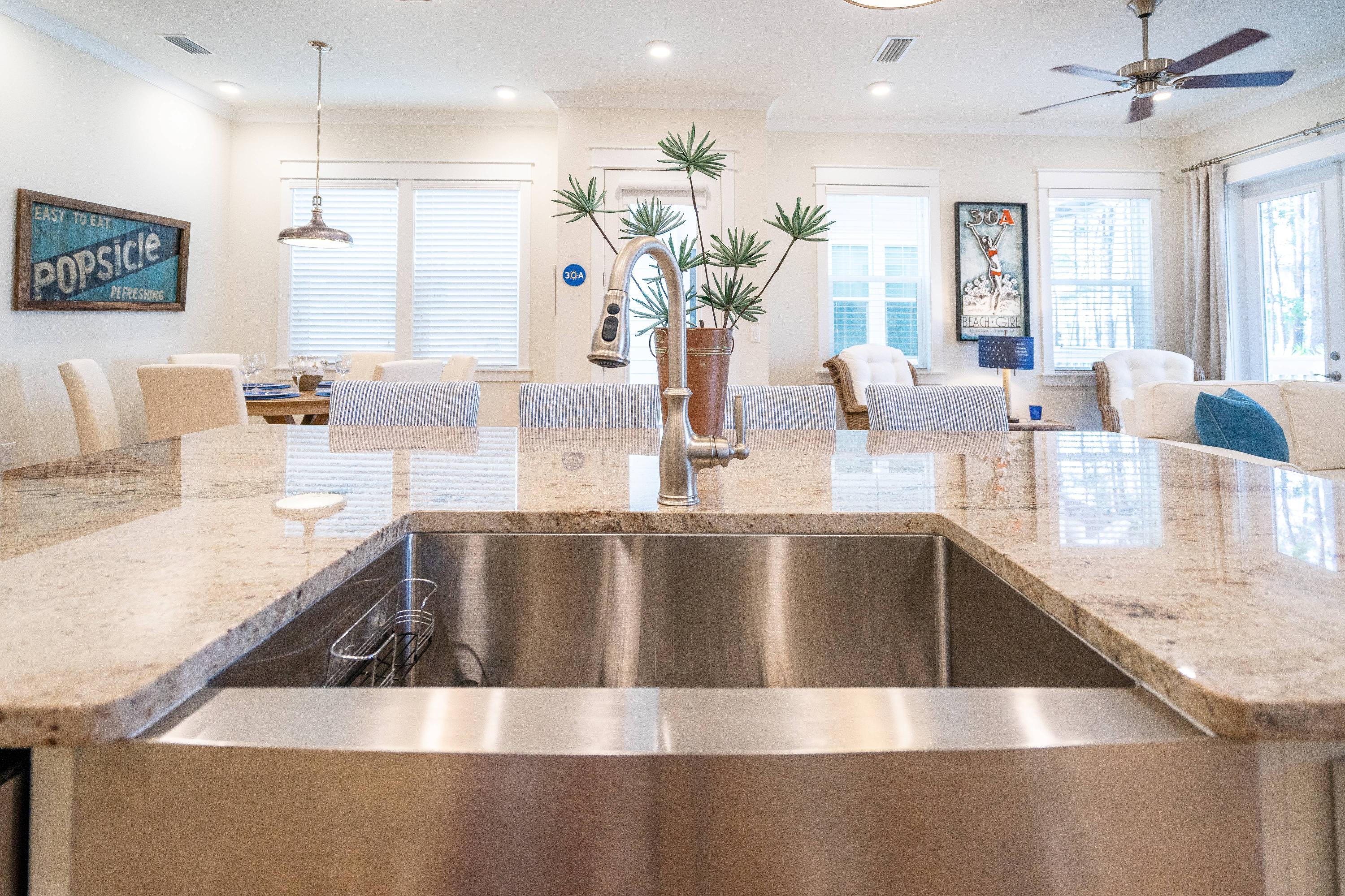89 East Pine Lands Loop, Unit A Inlet Beach, FL 32461 - Photo 8 of 41 a kitchen with kitchen island a large counter top space a sink stainless steel appliances