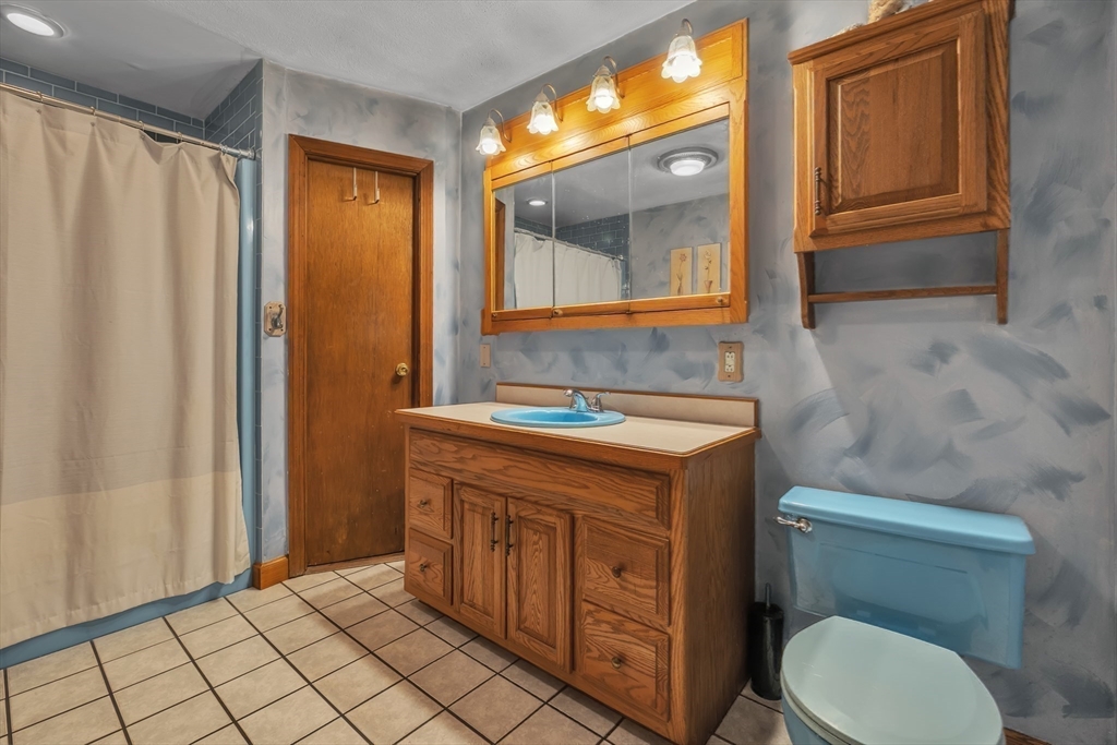 35 Laurelwood Road Rutland, MA 01543 - Photo 20 of 37 a bathroom with a granite countertop toilet sink and mirror