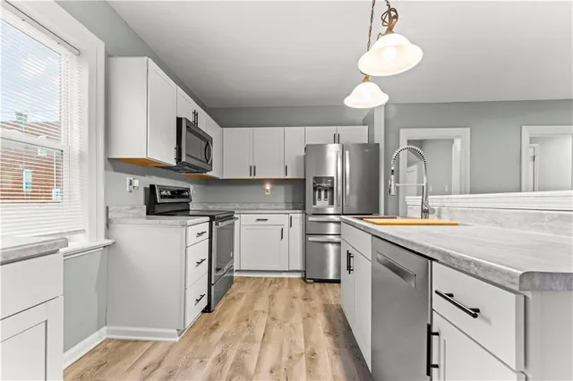 a kitchen with a sink cabinets and window