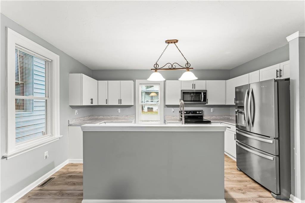 305 Perry Como Street Canonsburg, PA 15317 - Photo 12 of 33 a kitchen with stainless steel appliances granite countertop a refrigerator a stove a sink and white cabinets