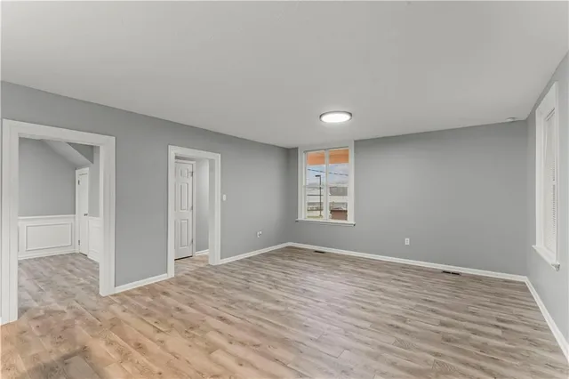 a view of a kitchen with wooden floor and windows