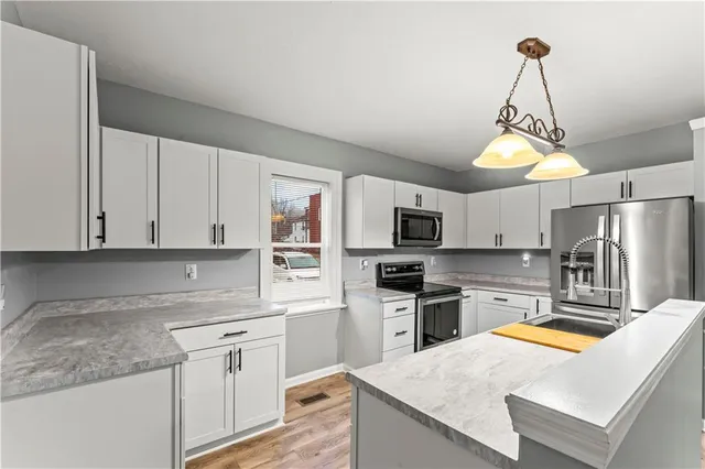 a kitchen with stainless steel appliances granite countertop a sink and cabinets