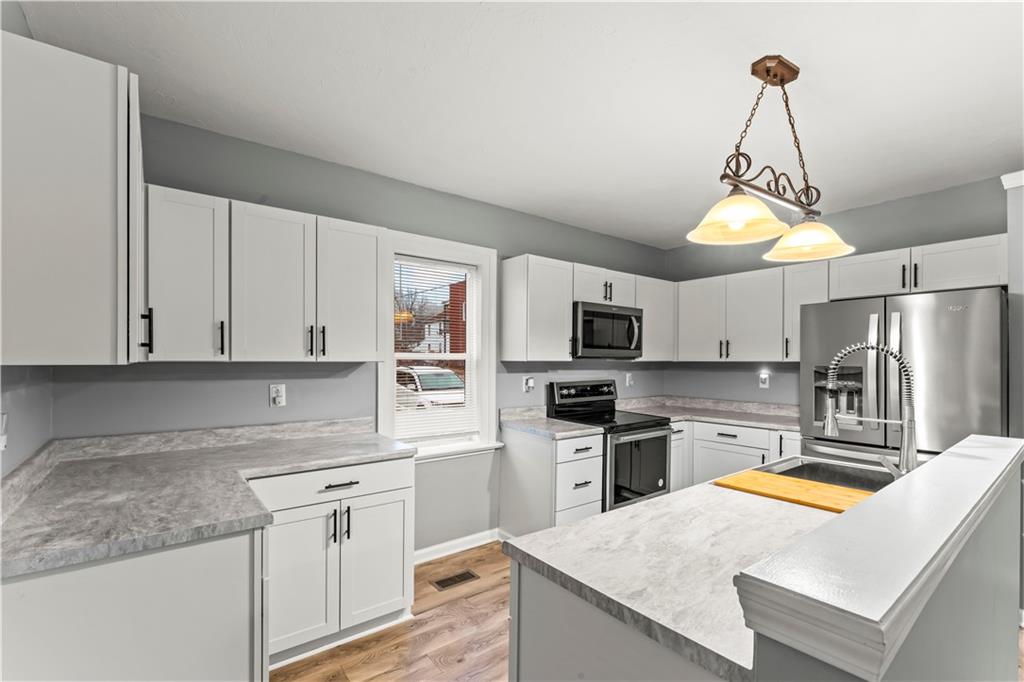 305 Perry Como Street Canonsburg, PA 15317 - Photo 10 of 24 a kitchen with stainless steel appliances granite countertop a sink dishwasher a refrigerator a stove top oven a counter space and cabinets