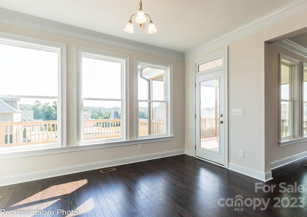 16327 Loch Raven Road Huntersville, NC 28078 - Photo 13 of 42 a view of an empty room with wooden floor and a window