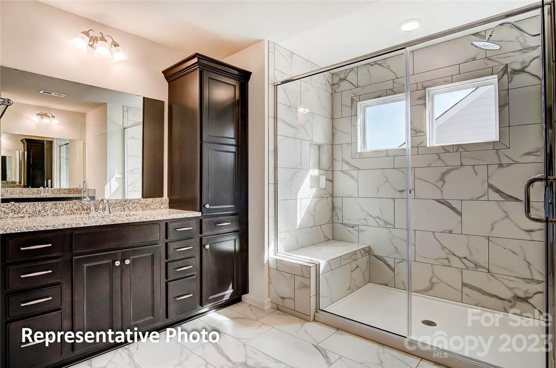 16327 Loch Raven Road Huntersville, NC 28078 - Photo 21 of 42 a bathroom with a granite countertop sink a toilet and shower