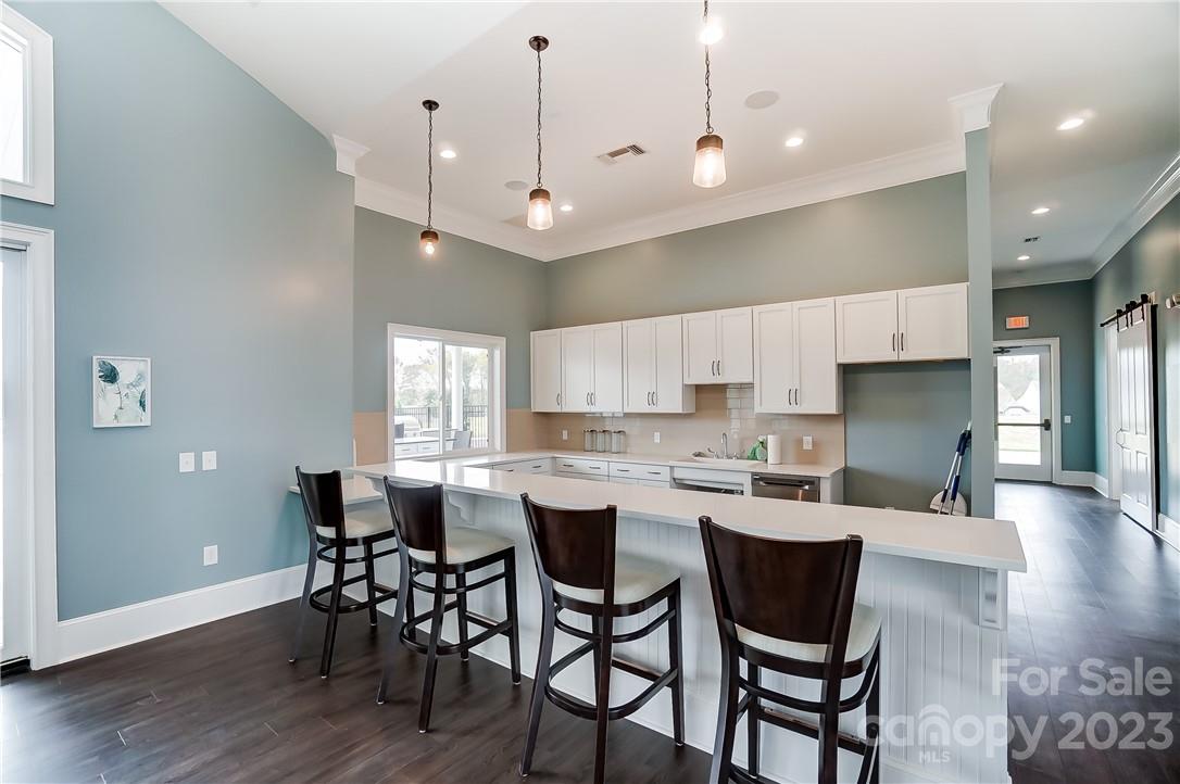 16327 Loch Raven Road Huntersville, NC 28078 - Photo 35 of 42 a large kitchen with a table and chairs
