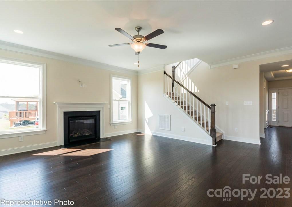 16327 Loch Raven Road Huntersville, NC 28078 - Photo 7 of 42 an empty room with wooden floor fireplace and windows