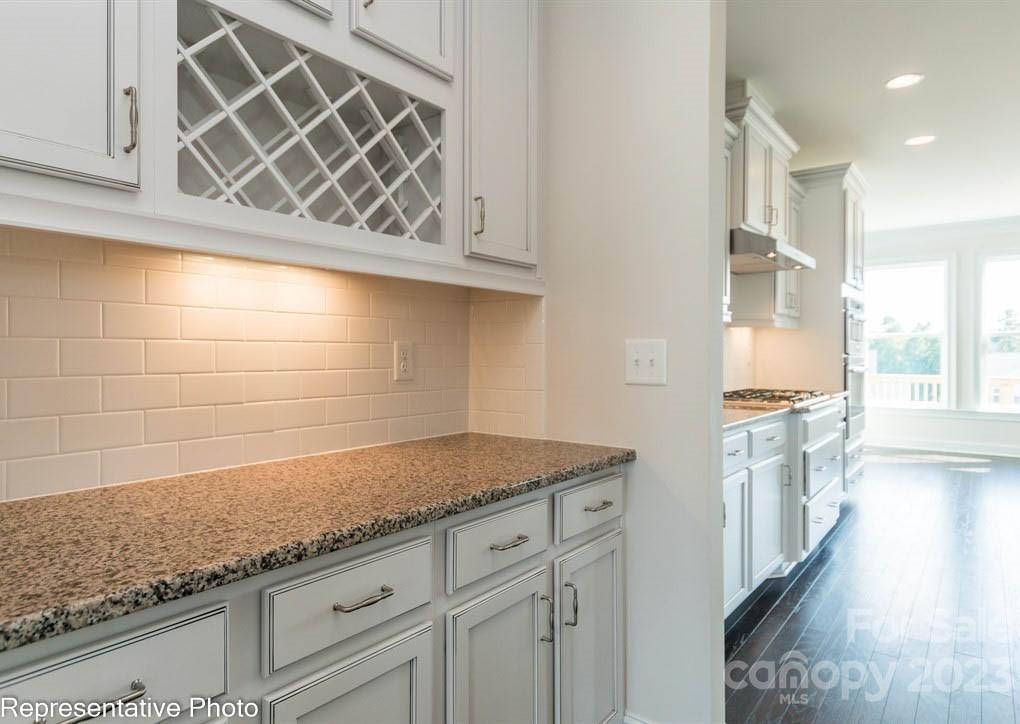 16327 Loch Raven Road Huntersville, NC 28078 - Photo 9 of 42 a kitchen with granite countertop white cabinets and white appliances