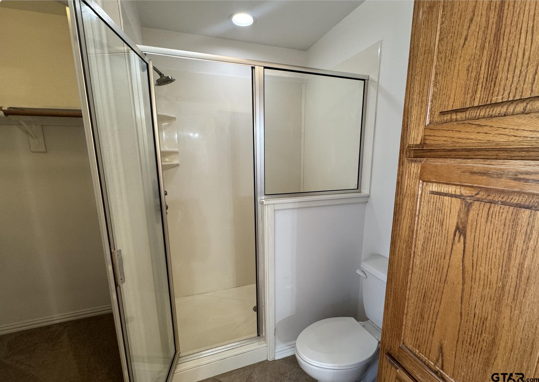 303 Kenneth Street Chandler, TX 75758 - Photo 15 of 33 a bathroom with a granite countertop toilet and a shower
