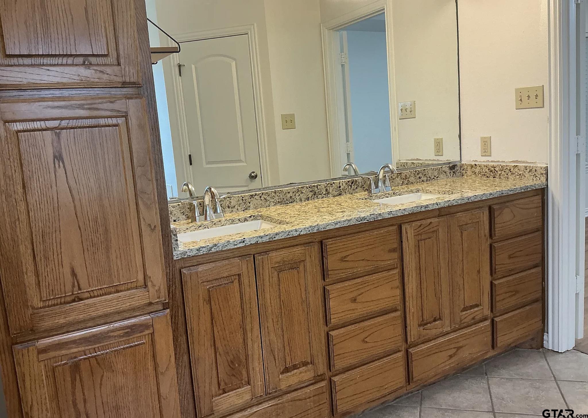 303 Kenneth Street Chandler, TX 75758 - Photo 16 of 33 a bathroom with a granite countertop sink and a mirror