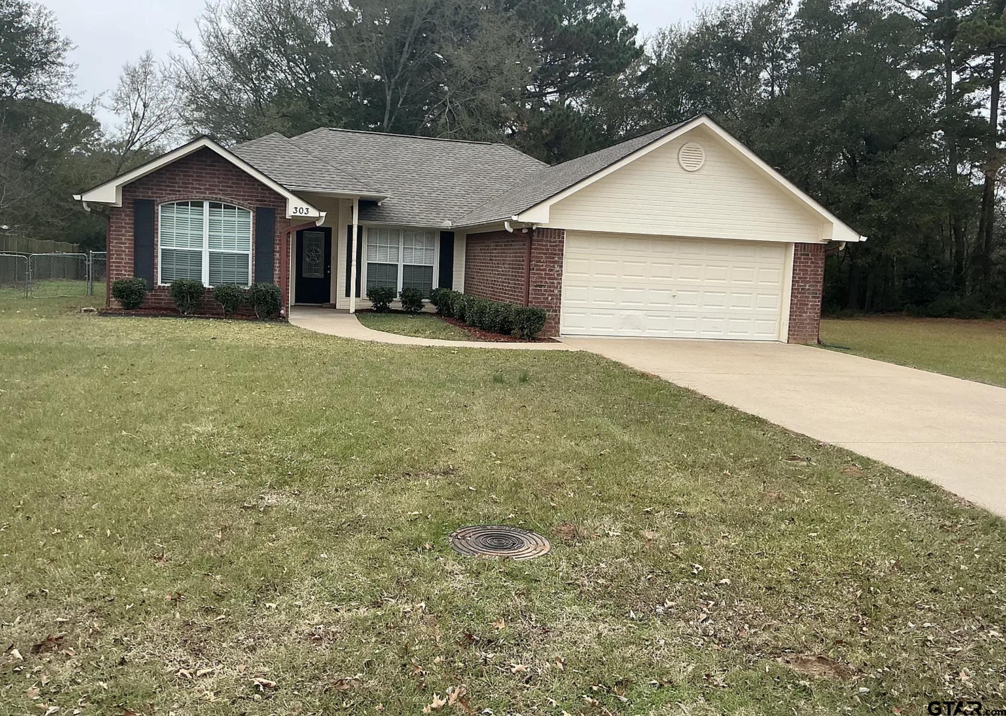 303 Kenneth Street Chandler, TX 75758 - Photo 33 of 33 a front view of a house with a garden and yard