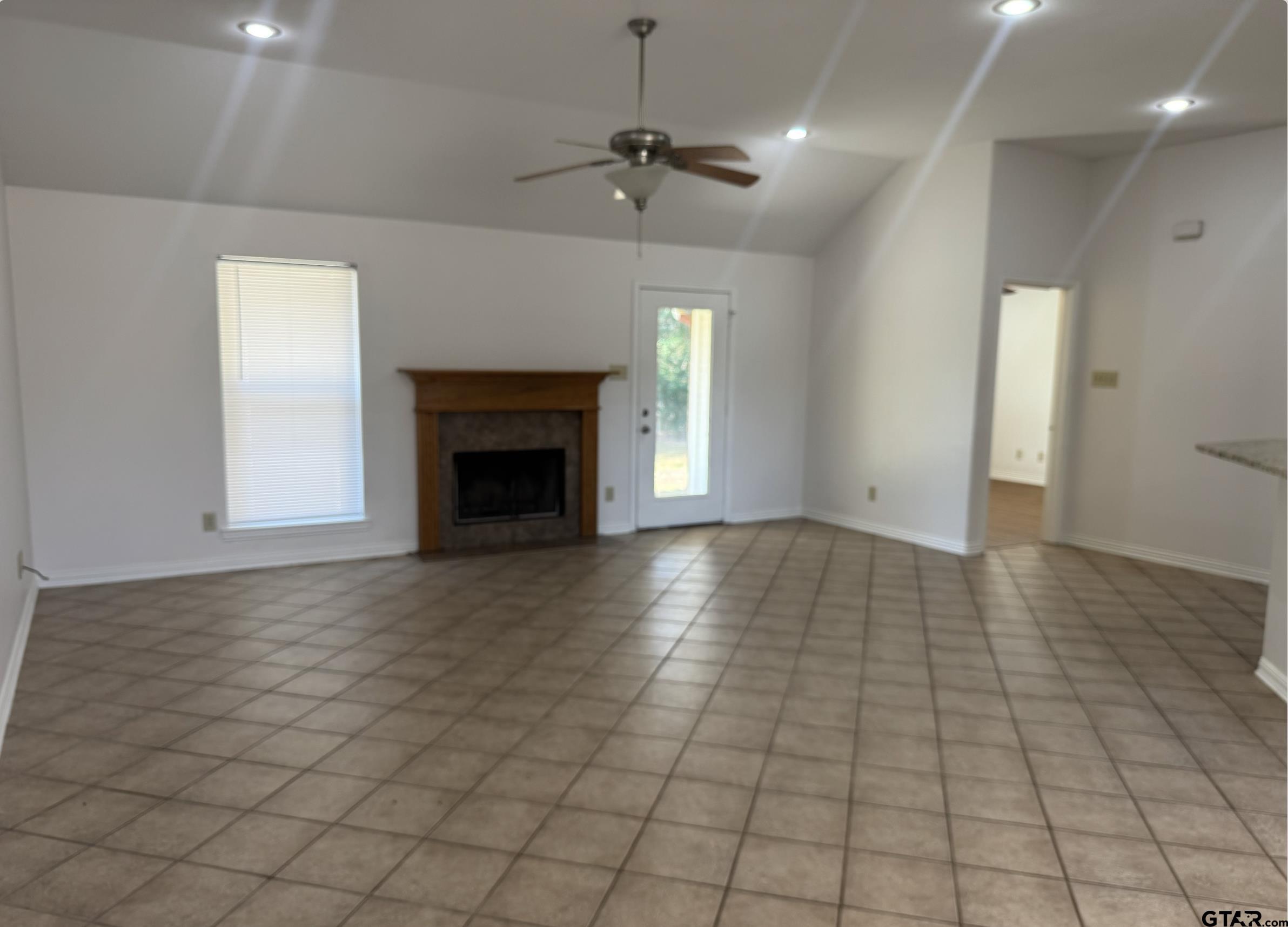 303 Kenneth Street Chandler, TX 75758 - Photo 7 of 33 an empty room with windows and a fireplace