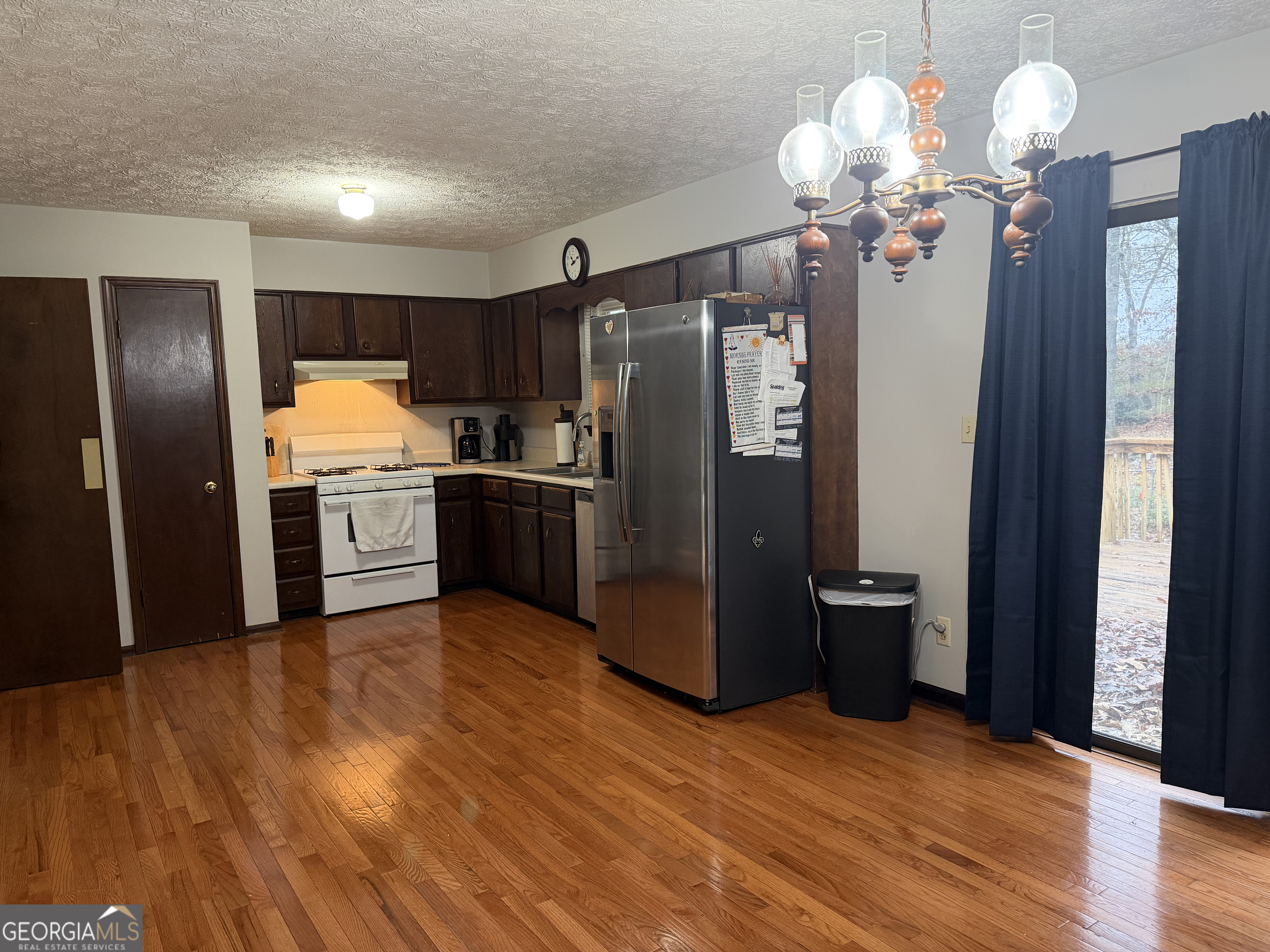 3403 Hidden Lane Rex, GA 30273 - Photo 11 of 27 a kitchen with stainless steel appliances granite countertop a refrigerator cabinets and wooden floor
