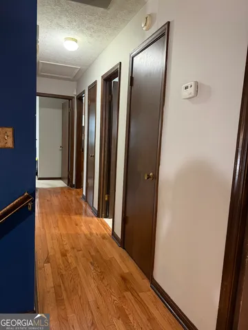 a view of a hallway with wooden floor