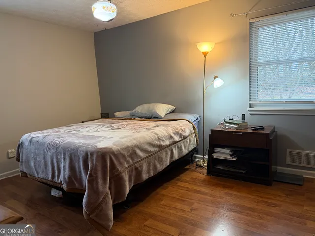 a bedroom with a bed and a lamp