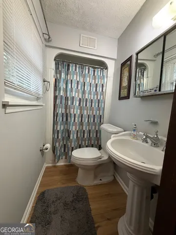 a white toilet sitting next to a bathroom sink