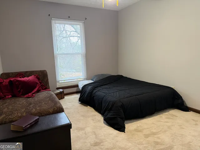 a bedroom with a bed and window
