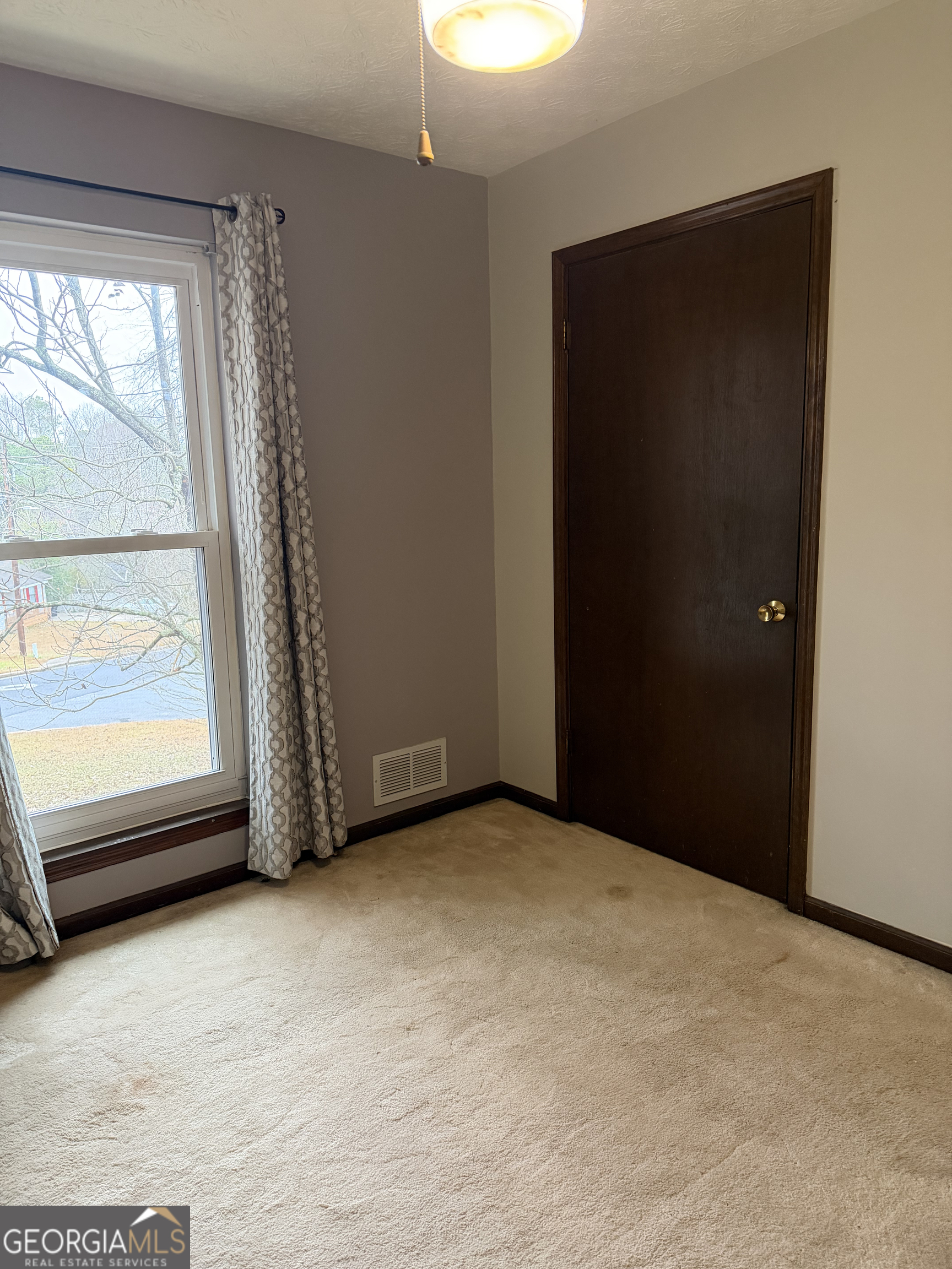 3403 Hidden Lane Rex, GA 30273 - Photo 18 of 27 a view of an empty room with a window