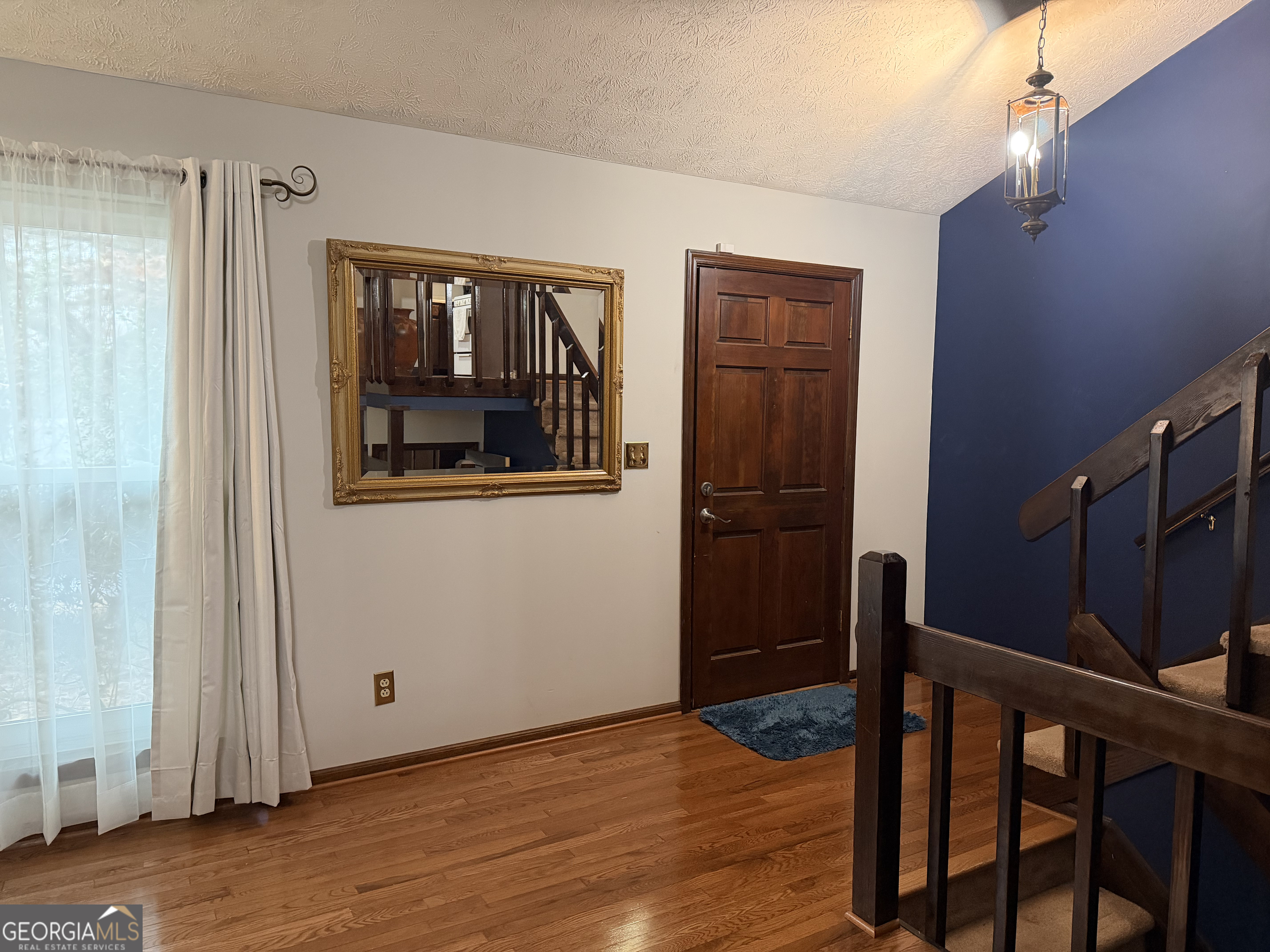 3403 Hidden Lane Rex, GA 30273 - Photo 3 of 27 a view of empty room with wooden floor and fan