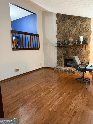 a view of a living room and wooden floor