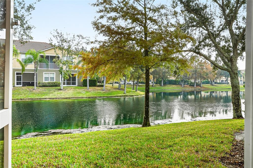 7928 Limestone Lane, Unit 19105 Sarasota, FL 34233 - Photo 20 of 37 a view of a lake with a house in a yard