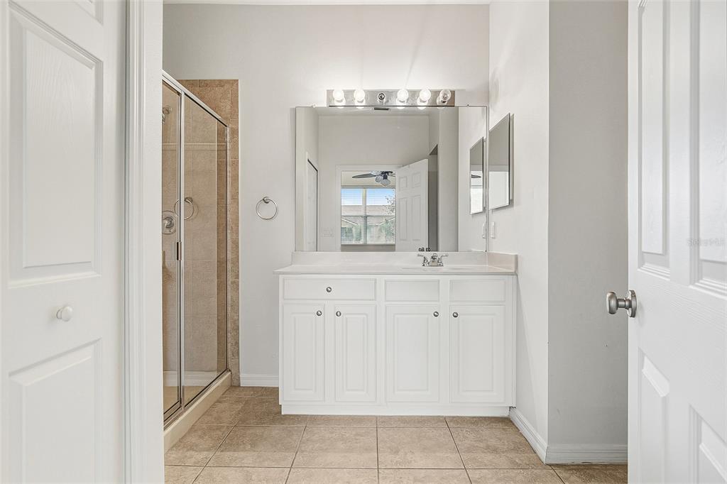 7928 Limestone Lane, Unit 19105 Sarasota, FL 34233 - Photo 27 of 37 a bathroom with a double vanity sink and a mirror
