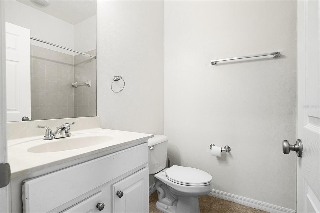 7928 Limestone Lane, Unit 19105 Sarasota, FL 34233 - Photo 31 of 37 a bathroom with a sink toilet and mirror