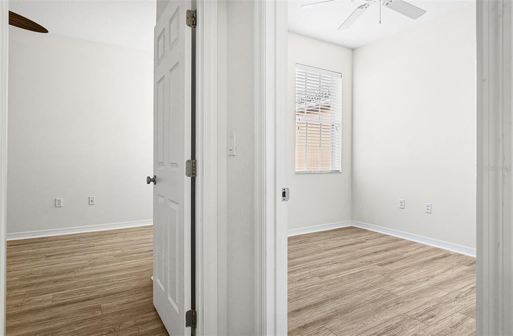 7928 Limestone Lane, Unit 19105 Sarasota, FL 34233 - Photo 32 of 37 a view of a hallway with wooden floor