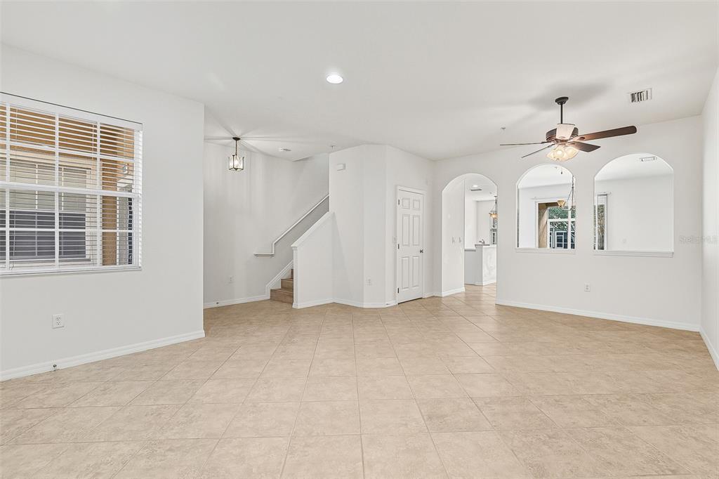7928 Limestone Lane, Unit 19105 Sarasota, FL 34233 - Photo 4 of 37 an empty room with windows and ceiling fan