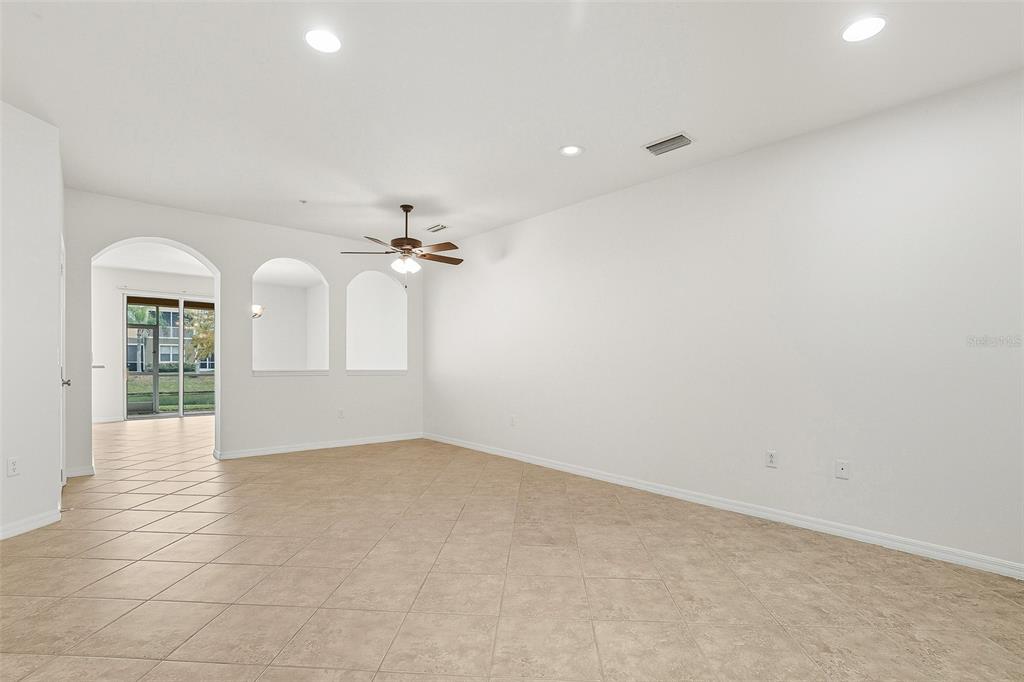 7928 Limestone Lane, Unit 19105 Sarasota, FL 34233 - Photo 6 of 37 wooden floor in an empty room with a window