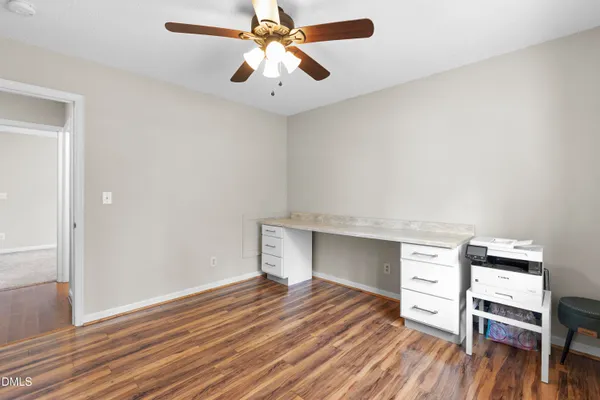 a kitchen with granite countertop a sink cabinets stainless steel appliances and wooden floor