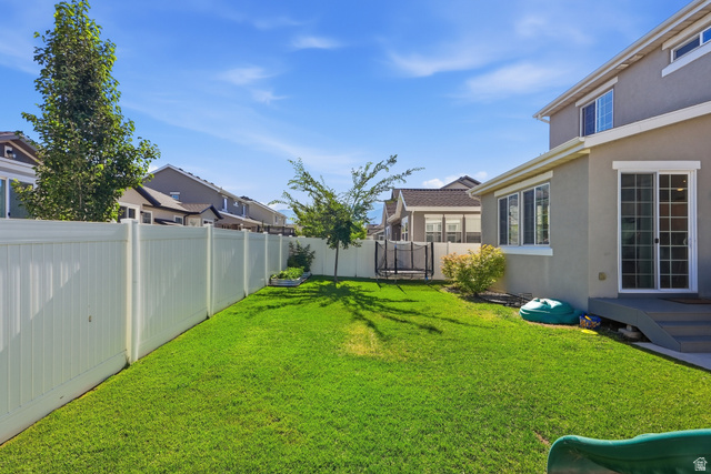 3244 West 1670th Street North Provo, UT 84601 - Photo 49 of 56 Expansive backyard featuring a manicured lawn, full vinyl privacy fencing, and mature trees