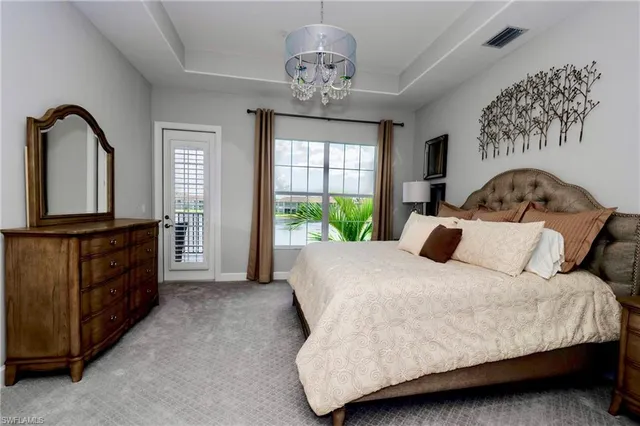 a bedroom with a large bed and a dresser next to a window