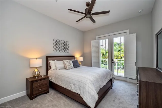 a bedroom with a large bed and a large window