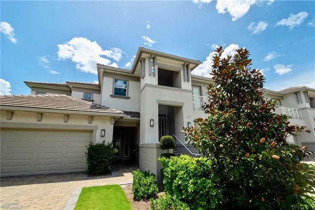 a front view of a house with a yard and a garage