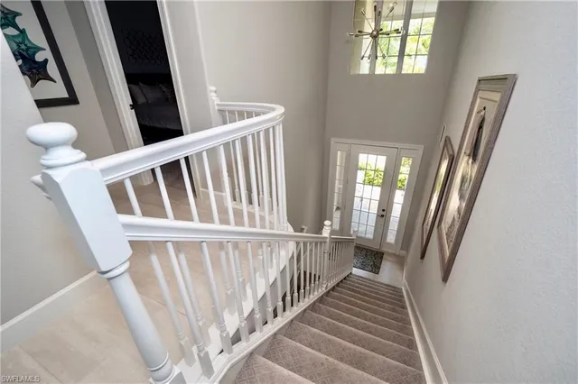 a view of staircase with railing and a floor to ceiling window