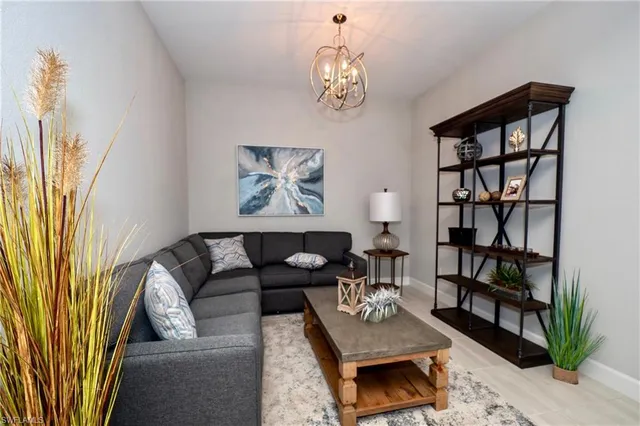 a living room with furniture and a bookshelf