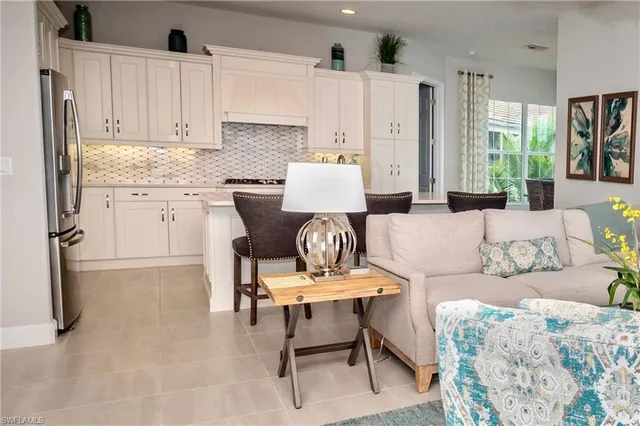 a living room with furniture a dining table and chair