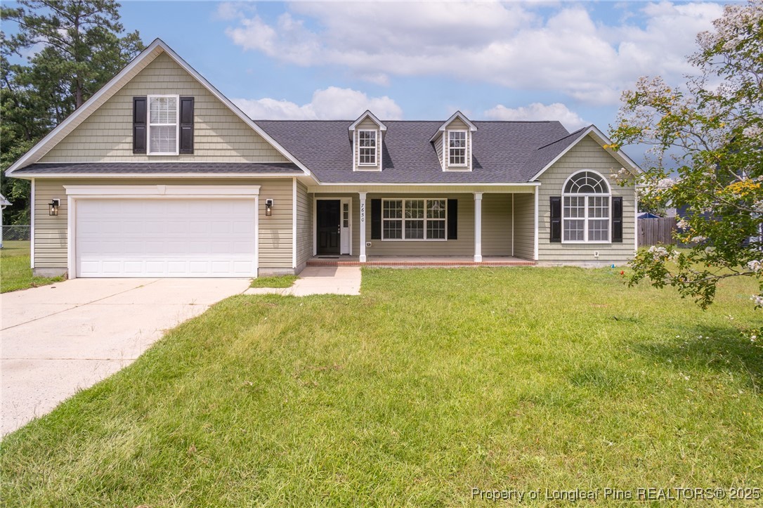 7650 Rufus Johnson Road Fayetteville, NC 28306 - Photo 1 of 43 a front view of a house with a garden
